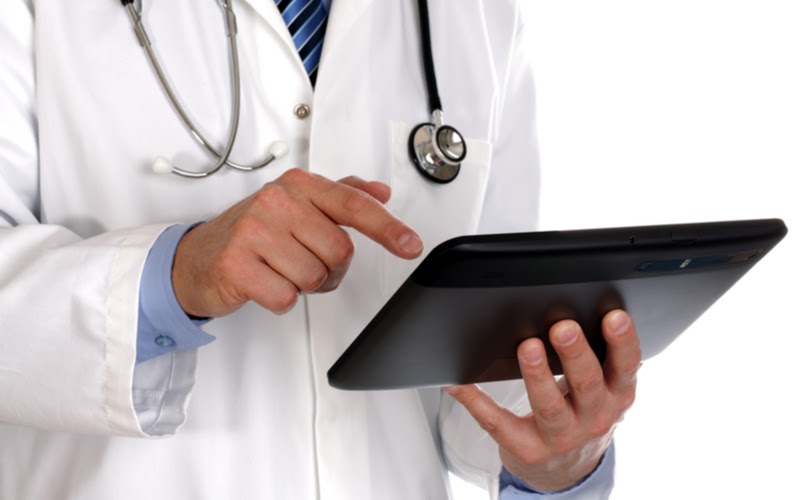 A doctor using a tablet