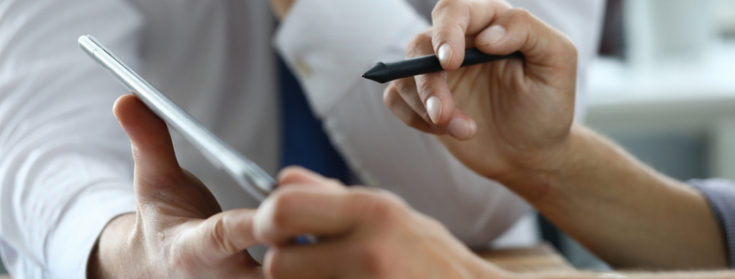 Image showing person signing tablet. Electronic signatures in Argentina are being increasingly used by individuals & businesses. Learn about the legality of use with this guide.