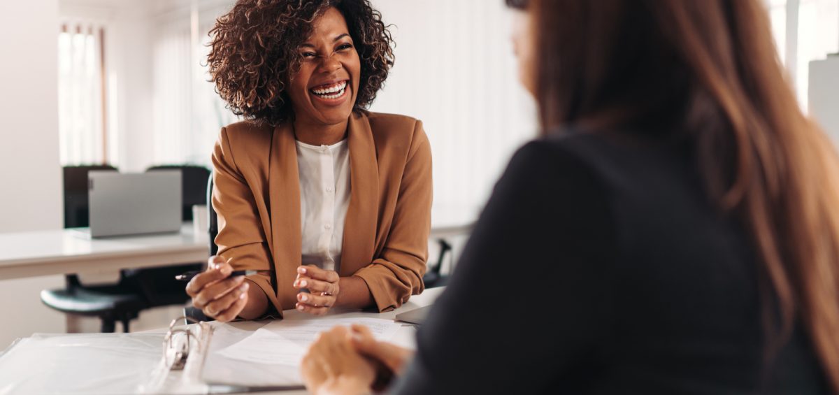Image showing a client meeting with two women. Maintaining client relationships is essential for businesses - eSign Genie can help.