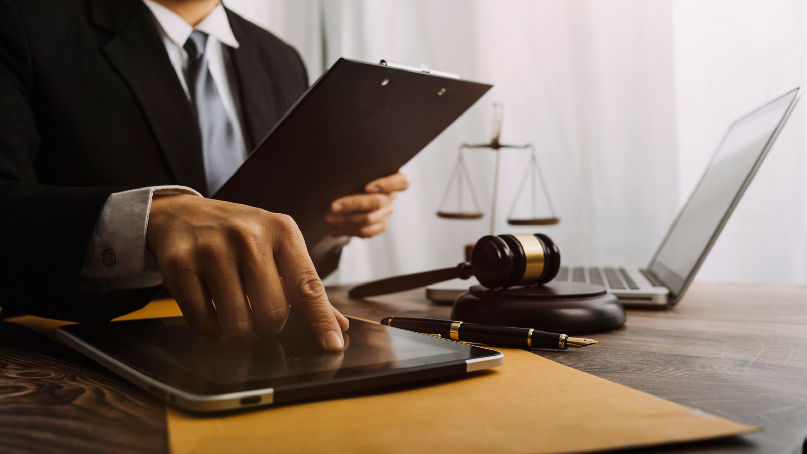 Image showing judge using a tablet, gavel. Learn how electronic signatures are court admissible with audit trails.
