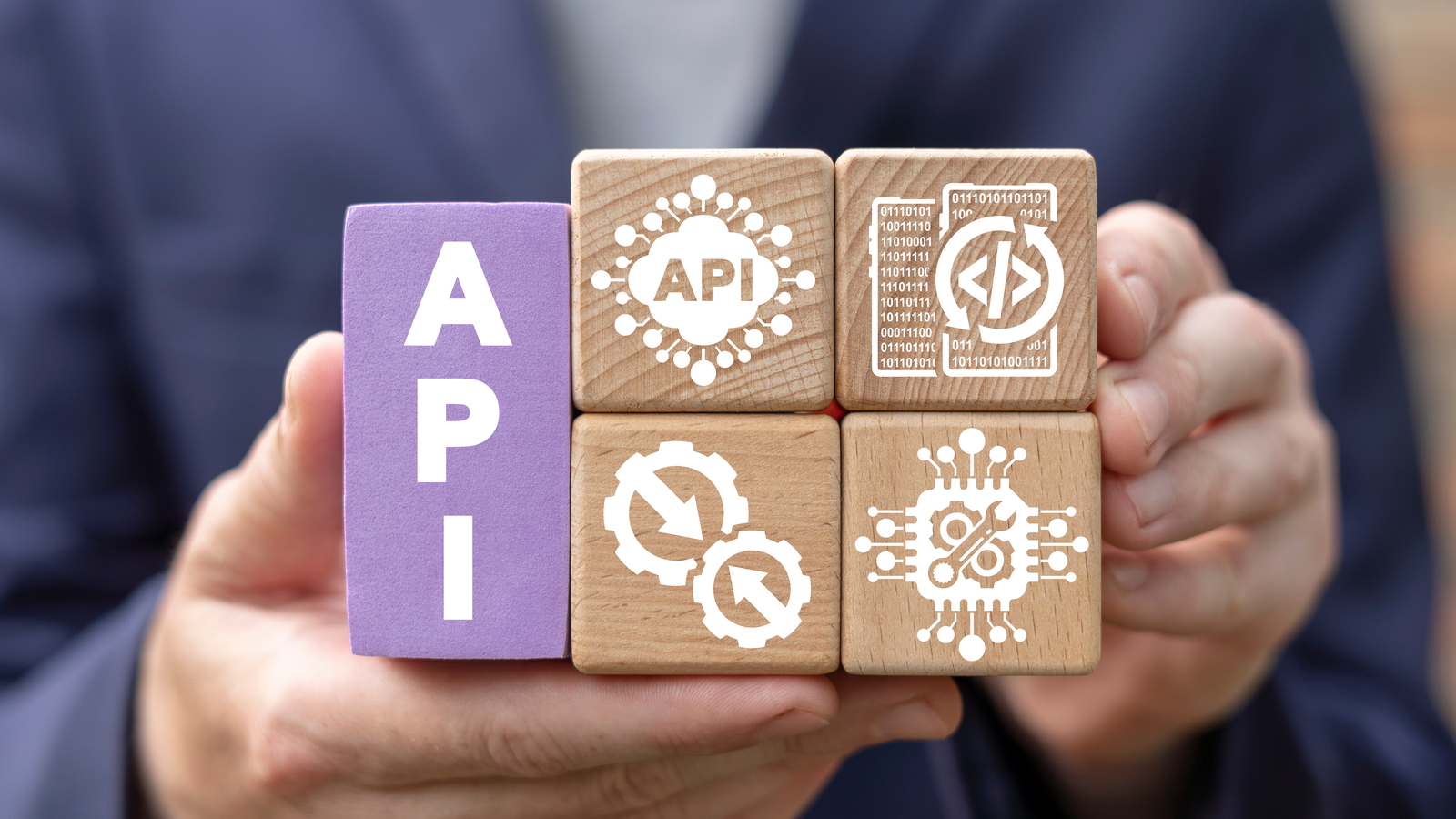 Image showing person holding blocks with API and symbols.
